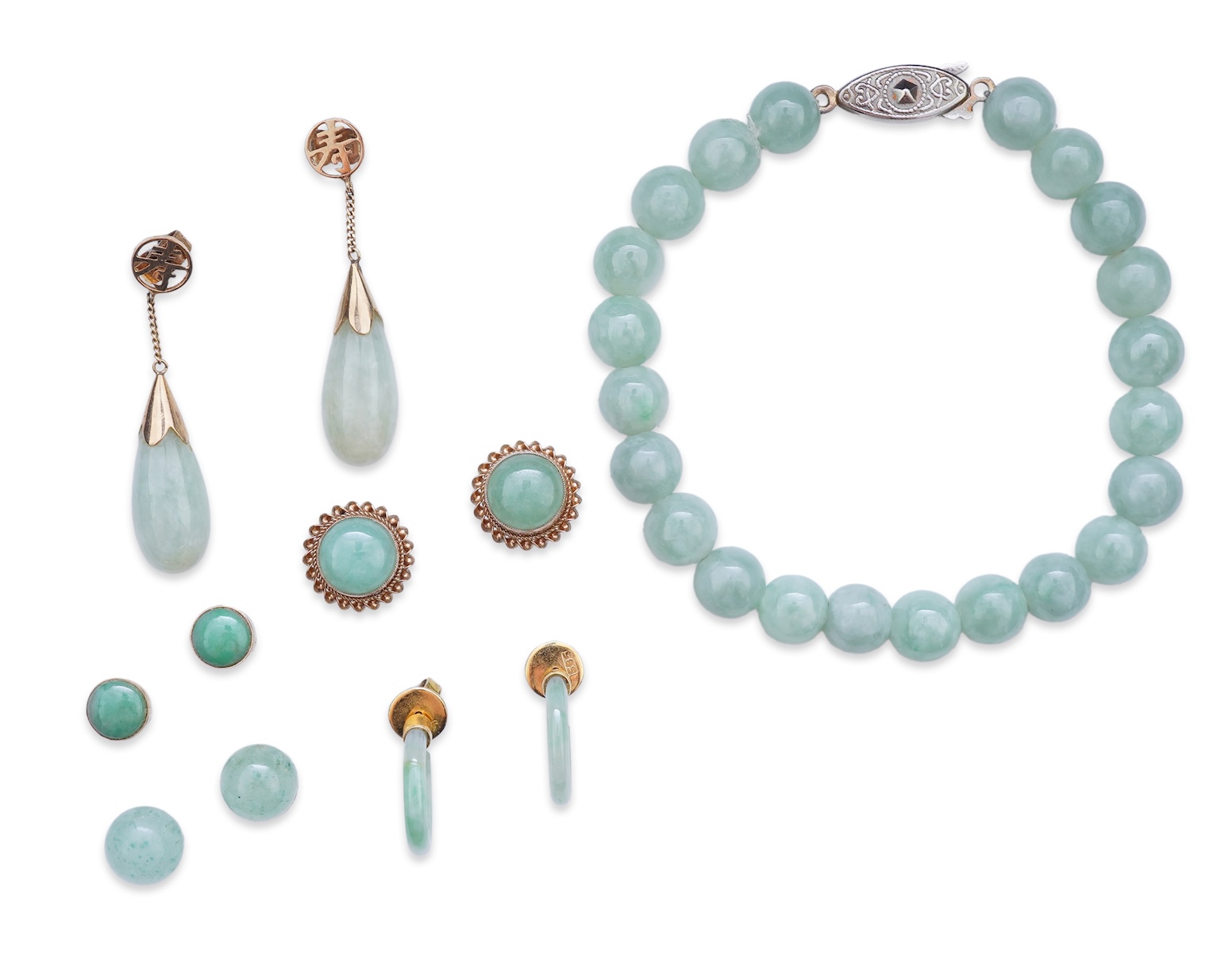 A collection of jadeite jewels, comprising: a bead bracelet with a silver clasp; together with three pairs of studs; one pair of hoop studs, one broken and restuck; and one pair of drop earrings, each set with jadeite, m